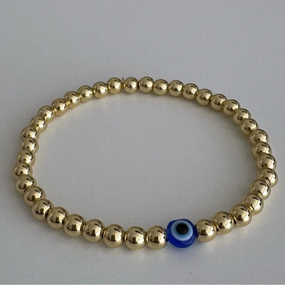 Gold Beaded Bracelet with Blue Evil Eye Bead